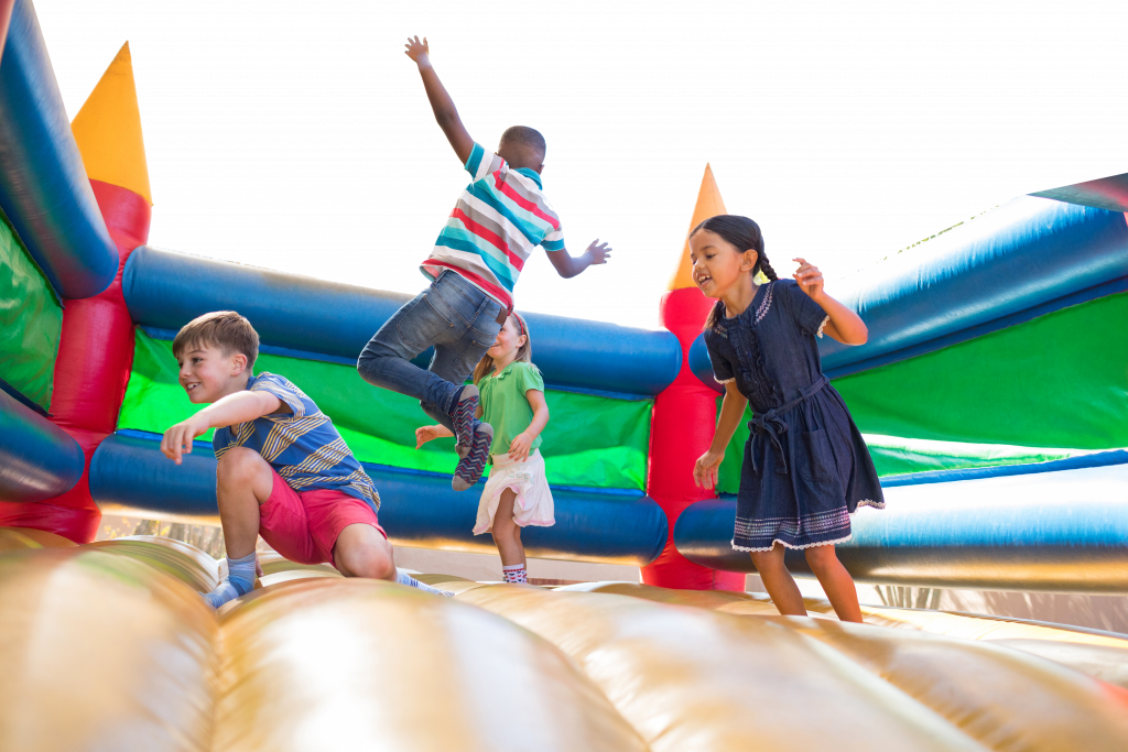 Kids jumping in an inflatable bounce house