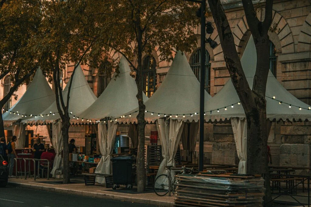 Peaked market tents with string lights