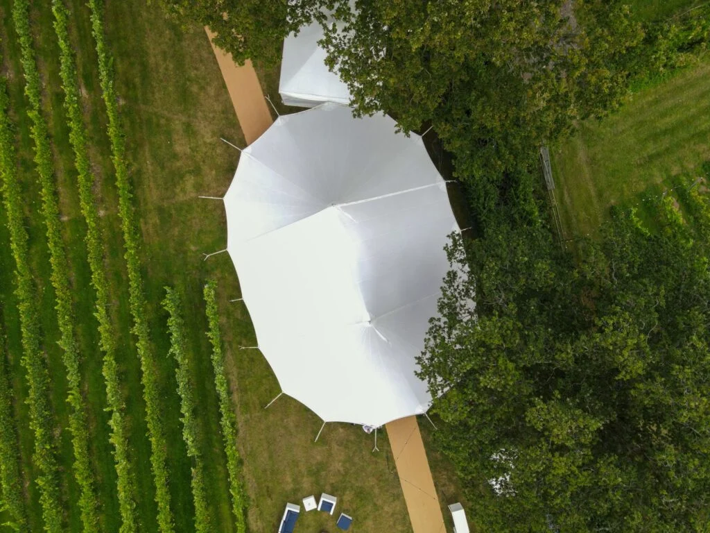 White tent in a vineyard, seen from above