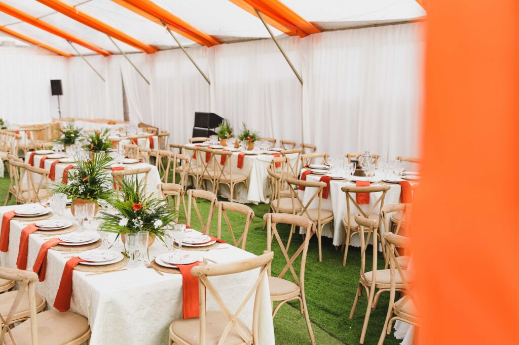 Tables set inside a white tent