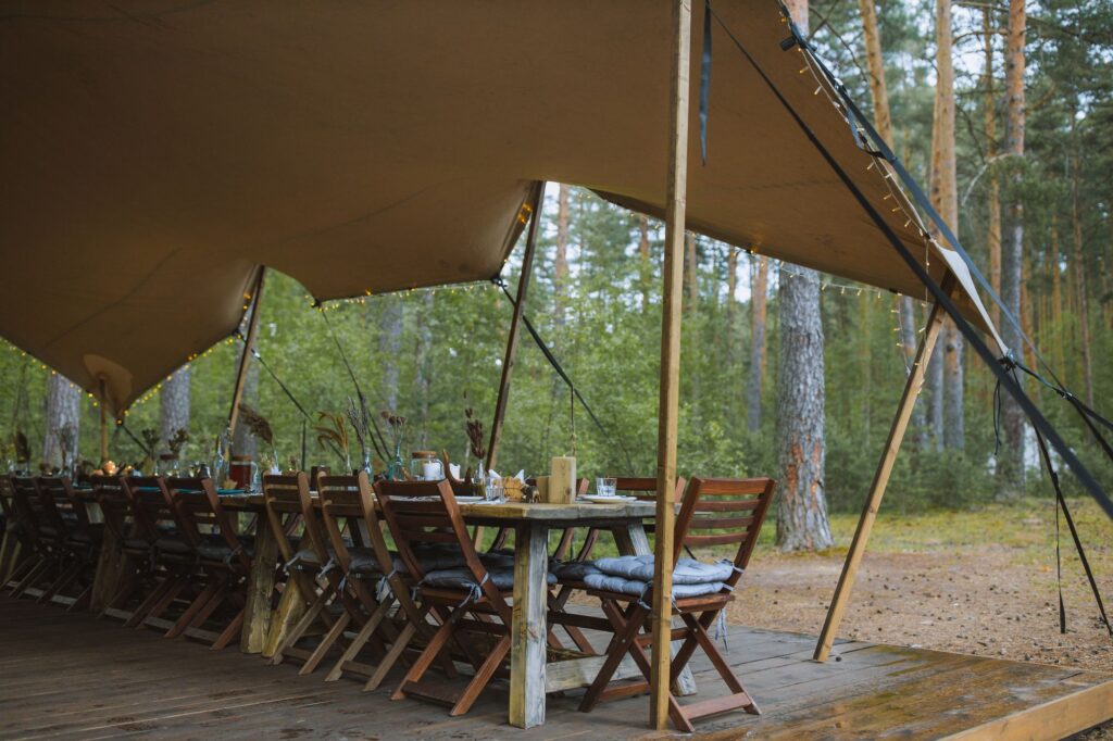 Dinner table under a stretch tent in the woods