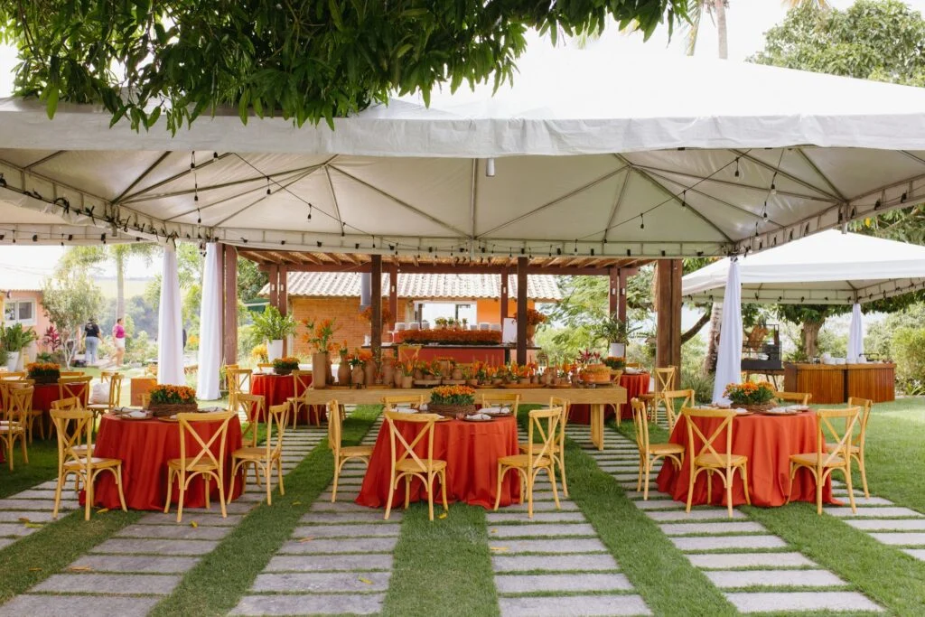 Outdoor reception set under a white canopy tent