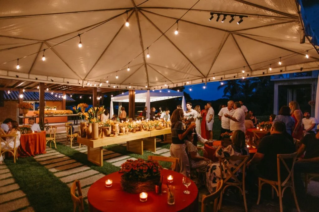 Evening party under a frame tent with string lights